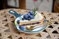 Delicious Blueberry tart with vanilla cream and blueberry filling on white dish. Royalty Free Stock Photo