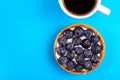 Delicious blueberry tartlet with vanilla cream and cup of coffee