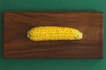 Delicious boiled corn. Corn on cob on rustic wooden table and wooden background from a natural wooden. Golden bright yellow corn. Royalty Free Stock Photo
