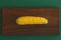 Delicious boiled corn. Corn on cob on rustic wooden table and wooden background from a natural wooden. Golden bright yellow corn. Royalty Free Stock Photo