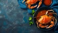 Delicious boiled crabs with sauce in bowl on blue tablecloth, top view. Space for text Royalty Free Stock Photo