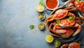 Delicious boiled crabs with sauce in bowl on blue tablecloth, top view. Space for text Royalty Free Stock Photo