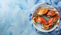 Delicious boiled crabs with sauce in bowl on blue tablecloth, top view. Space for text Royalty Free Stock Photo