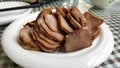 boiled pork tongue on a white plate on the table Royalty Free Stock Photo