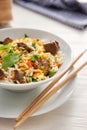 Delicious boiled rice with meat and vegetables in bowl on table Royalty Free Stock Photo