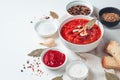 Delicious borscht with garlic and bay leaf on a white background.Vegetable soup with tomato and beetroot, bread, garlic and sour