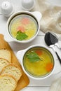 Delicious bouillon served on white wooden table, flat lay