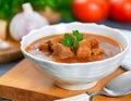A delicious bowl of traditional Hungarian goulash, rich and hearty, garnished with fresh parsley Royalty Free Stock Photo