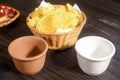 Delicious bowl of traditional Mexican Guacamole, nachos and guacamole ingredients: Avocado, onion, cilantro, hot pepper tomatoes Royalty Free Stock Photo