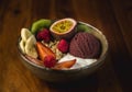 Delicious bowl of yogurt, ice-cream, nuts and fresh fruits on a wooden surface Royalty Free Stock Photo