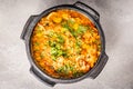 Delicious Brazilian fish moqueca with tomato, onion, olive oil, coriander and orocum seed. Made in clay pot on white table and Royalty Free Stock Photo