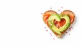 Delicious bread toasts in the shape of heart, with fresh avocado and red salted fish, on a white background