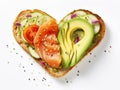 Delicious bread toasts in the shape of heart, with fresh avocado and red salted fish, on a white background