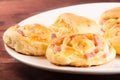 Delicious breads with cubed bacon on wood table