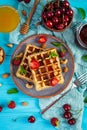 Delicious breakfast with belgian waffles. Waffels with strawberry and berry jam
