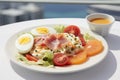 Delicious breakfast of boiled eggs, bacon and fresh garden salad on a white plate