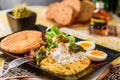 Breakfast with boiled eggs, pumpkin puree, lettuce, cheese and fresh bread on a black plate Royalty Free Stock Photo