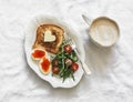 Delicious breakfast, brunch - toasts with butter, boiled eggs with red caviar, fresh salad and coffee on a light background, top Royalty Free Stock Photo