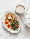 Delicious breakfast, brunch - toasts with butter, boiled eggs with red caviar, fresh salad and coffee on a light background, top Royalty Free Stock Photo