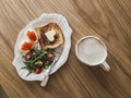 Delicious breakfast, brunch - toasts with butter, boiled eggs with red caviar, fresh salad and coffee on a wooden background, top Royalty Free Stock Photo