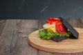 Delicious breakfast charcoal sandwiches on wooden cutting boards with copy space