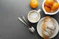 Delicious breakfast coffee with croissant and citrus fruits - oranges. Morning caffeine. French, fresh pastry and cup of coffee or Royalty Free Stock Photo