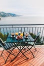 Delicious breakfast with coffee, pastry, and orange juice served on the balcony with sea view Royalty Free Stock Photo