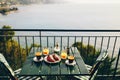 Delicious breakfast with coffee, pastry, and orange juice served on the balcony with sea view Royalty Free Stock Photo