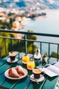 Delicious breakfast with coffee, pastry, and orange juice served on the balcony with sea view Royalty Free Stock Photo