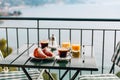 Delicious breakfast with coffee, pastry, and orange juice served on the balcony with sea view Royalty Free Stock Photo