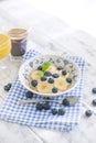Delicious breakfast composition. Bowl of organic muesli with banana, linseeds, fresh berries , coffee, fover rustic wooden