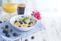 Delicious breakfast composition. Bowl of organic muesli with banana, linseeds, fresh berries , coffee, fover rustic wooden