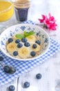 Delicious breakfast composition. Bowl of organic muesli with banana, linseeds, fresh berries , coffee, fover rustic wooden