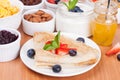 Delicious breakfast - crepes with fresh berries and honey