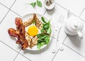 Delicious breakfast - crepes with fried egg and bacon on a light background, top view Royalty Free Stock Photo