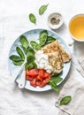 Delicious breakfast - crepes with smoked salmon, spinach, cream fresh on a light background, top view