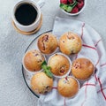 Delicious breakfast food concept. Coffee, raspberry muffins on concrete table. Top view, flat lay Royalty Free Stock Photo
