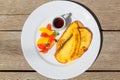 Delicious breakfast with french toasts with fried banana, honey