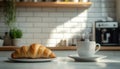 Delicious breakfast with fresh croissant and cup of hot drink in kitchen Royalty Free Stock Photo