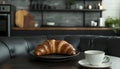 Delicious breakfast with fresh croissant and cup of hot drink in kitchen Royalty Free Stock Photo