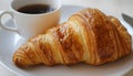 Delicious breakfast with fresh croissant and cup of hot drink in kitchen Royalty Free Stock Photo