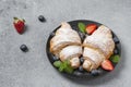 Delicious breakfast with fresh croissants and fresh ripe berries. Freshly baked croissants with strawberries and blueberries. Royalty Free Stock Photo