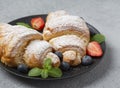 Delicious breakfast with fresh croissants and fresh ripe berries. Freshly baked croissants with strawberries and blueberries. Royalty Free Stock Photo