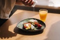 Delicious breakfast at home. Woman salt Sandwich with fresh sliced avocado above rye toasted bread with cherry tomatoes Royalty Free Stock Photo