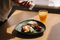 Delicious breakfast at home. Woman salt Sandwich with fresh sliced avocado above rye toasted bread with cherry tomatoes Royalty Free Stock Photo