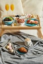 Delicious breakfast in bed served on tray Royalty Free Stock Photo