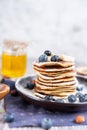 Delicious Breakfast pancakes on a plate with blueberries and honey