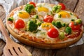 Delicious breakfast: pizza with eggs, broccoli, tomatoes and her Royalty Free Stock Photo