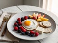 Delicious Breakfast Plate Fried Egg Berries Cheese Crackers Fruit. Royalty Free Stock Photo