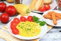 Delicious breakfast of scrambled eggs, baguettes and vegetable Royalty Free Stock Photo